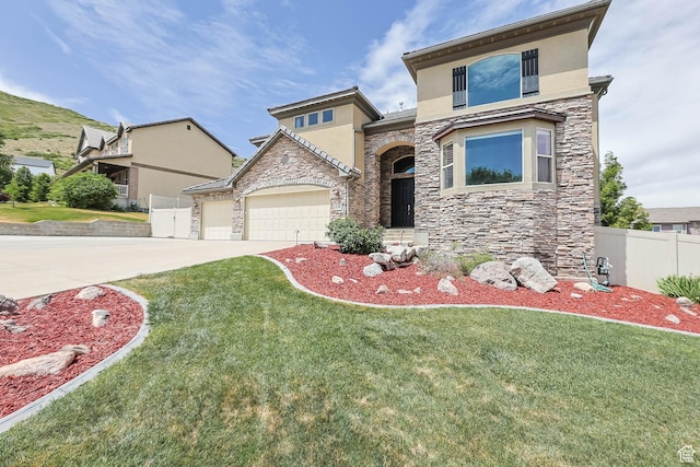 14346 S Fort Duchesne Cv, Herriman, UT 84096 - view of front of house featuring stone siding, stucco siding, an attached garage, and driveway