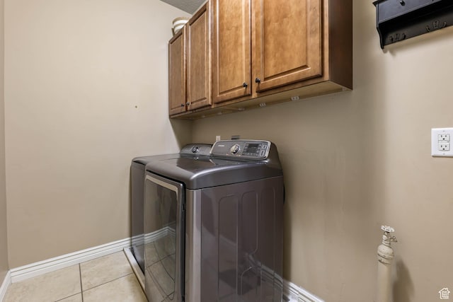 14346 S Fort Duchesne Cv, Herriman, UT 84096 - laundry room featuring washer and clothes dryer, cabinet space, and light tile patterned flooring