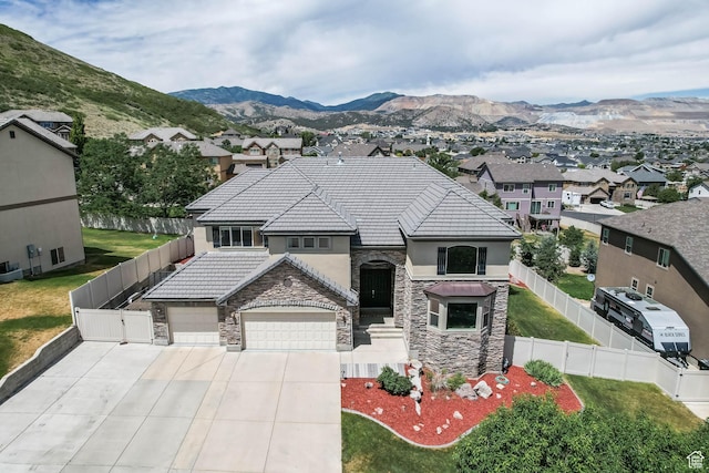 14346 S Fort Duchesne Cv, Herriman, UT 84096 - french country style house featuring stone siding, stucco siding, driveway, and a garage