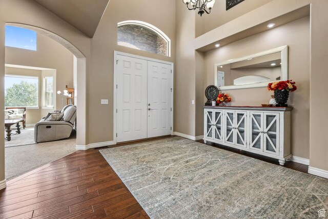 14346 S Fort Duchesne Cv, Herriman, UT 84096 - entryway featuring arched walkways, hardwood / wood-style floors, and a high ceiling