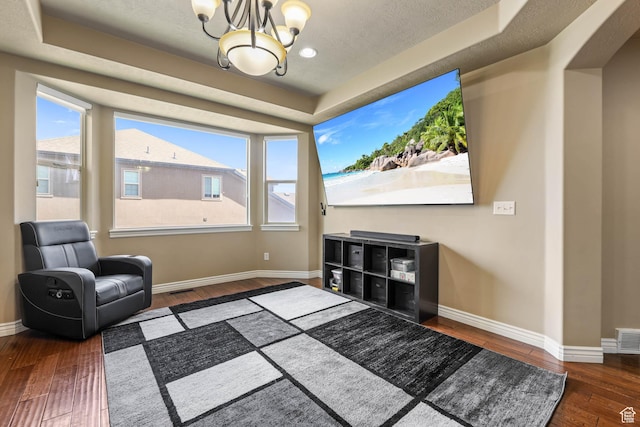 14346 S Fort Duchesne Cv, Herriman, UT 84096 - sitting room featuring a raised ceiling, hardwood / wood-style floors, a chandelier, and healthy amount of natural light