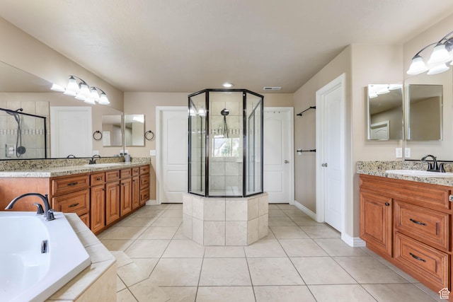 14346 S Fort Duchesne Cv, Herriman, UT 84096 - bathroom featuring a stall shower, two vanities, a bath, and tile patterned flooring