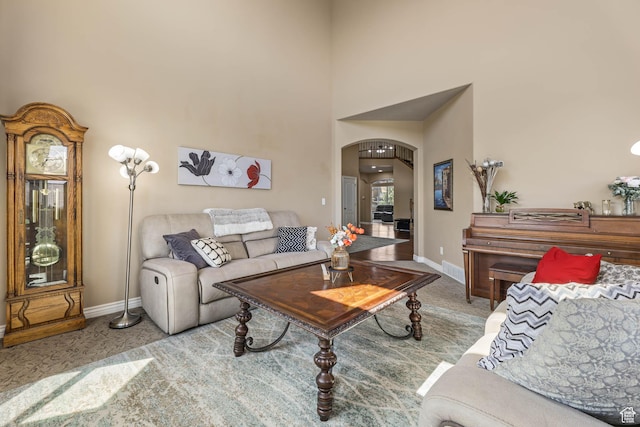 14346 S Fort Duchesne Cv, Herriman, UT 84096 - carpeted living area featuring arched walkways and a towering ceiling
