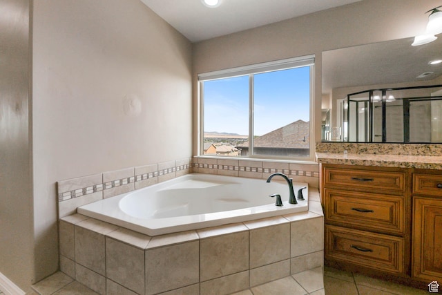 14346 S Fort Duchesne Cv, Herriman, UT 84096 - bathroom with vanity, a garden tub, tile patterned flooring, and a stall shower