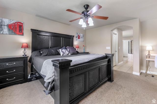 14346 S Fort Duchesne Cv, Herriman, UT 84096 - bedroom with arched walkways, light carpet, ceiling fan, and light tile patterned flooring