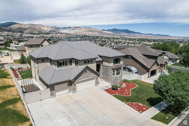 14346 S Fort Duchesne Cv, Herriman, UT 84096 - view of front of house featuring stone siding, stucco siding, a gate, concrete driveway, and a residential view
