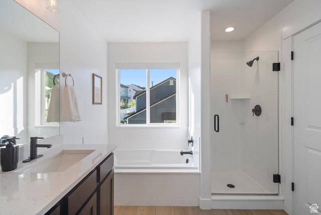 2437 E Ember Dr, Draper, UT 84020 - full bathroom with vanity, a stall shower, a bath, and wood finished floors