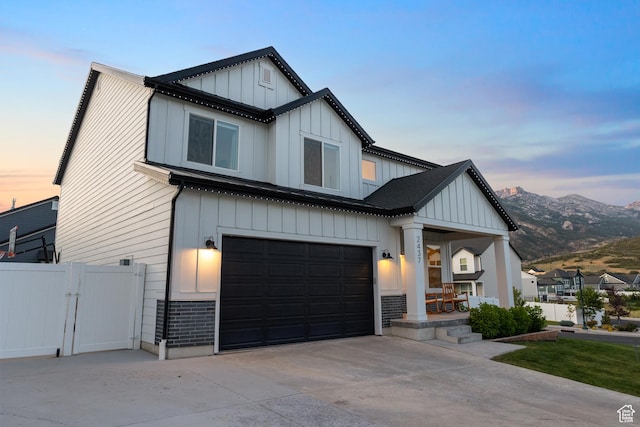 2437 E Ember Dr, Draper, UT 84020 - modern inspired farmhouse with board and batten siding, a garage, concrete driveway, and a gate