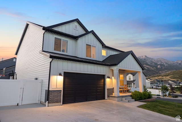 2437 E Ember Dr, Draper, UT 84020 - modern farmhouse with an attached garage, board and batten siding, concrete driveway, a standing seam roof, and a gate