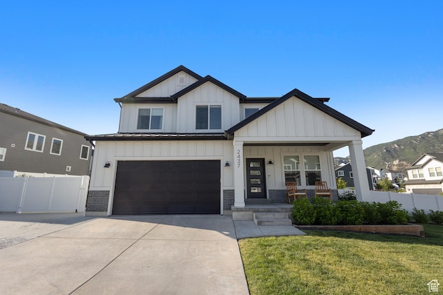 2437 E Ember Dr, Draper, UT 84020 - modern farmhouse with a porch, board and batten siding, driveway, an attached garage, and a mountain view
