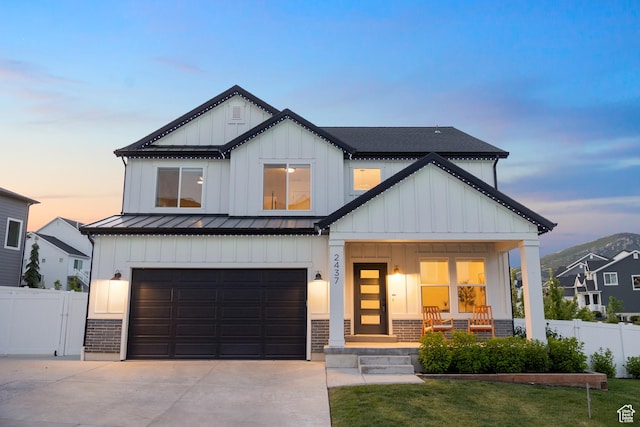 2437 E Ember Dr, Draper, UT 84020 - modern farmhouse style home with a standing seam roof, board and batten siding, a porch, driveway, and a garage