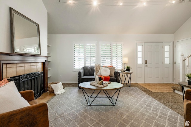 1241 N 575 W, Centerville, UT 84014 - living area with lofted ceiling, a tiled fireplace, tile patterned floors, and stairway