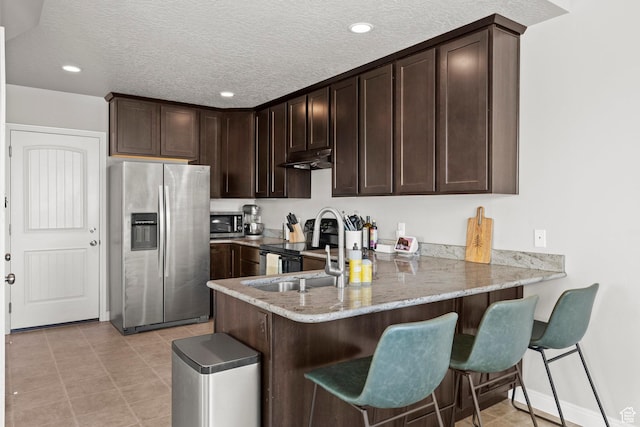 3733 N Prairie Grass Dr W, Lehi, UT 84043 - kitchen featuring appliances with stainless steel finishes, dark brown cabinetry, under cabinet range hood, a peninsula, and recessed lighting