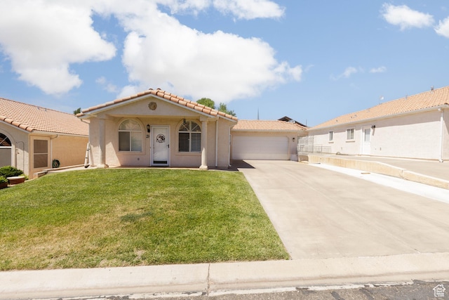 504 E Telegraph Unit 39, Washington, UT 84780 - mediterranean / spanish-style house featuring concrete driveway, a tile roof, an attached garage, stucco siding, and a front lawn