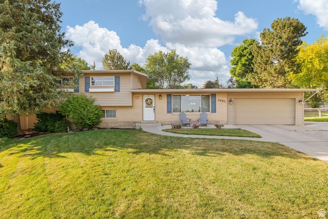 3993 N 750 E, Provo, UT 84604 - split level home with an attached garage, concrete driveway, brick siding, and a front lawn