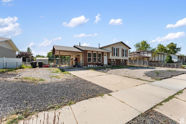 2601 N 720 W, Clinton, UT 84015 - tri-level home featuring concrete driveway and an attached carport