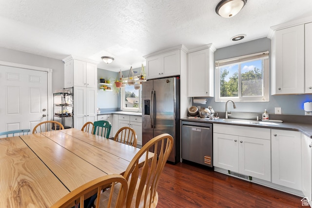 2601 N 720 W, Clinton, UT 84015 - kitchen featuring stainless steel appliances, a textured ceiling, white cabinetry, and dark wood finished floors