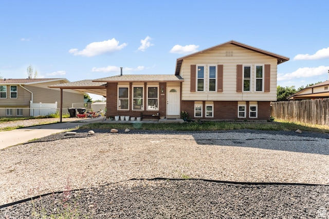 2601 N 720 W, Clinton, UT 84015 - tri-level home featuring concrete driveway, brick siding, and a carport