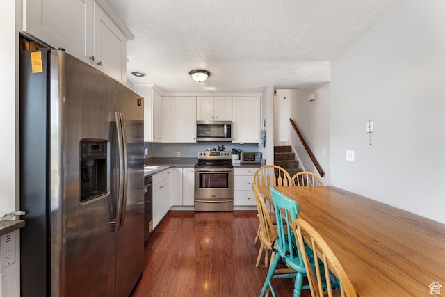 2601 N 720 W, Clinton, UT 84015 - kitchen featuring stainless steel appliances, white cabinets, a textured ceiling, dark wood-type flooring, and dark countertops