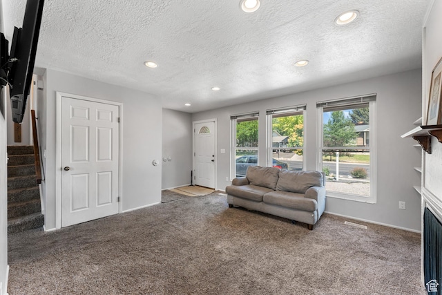 2601 N 720 W, Clinton, UT 84015 - carpeted living area featuring stairs, a fireplace, a textured ceiling, and recessed lighting