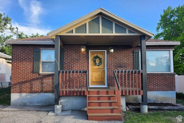 911 E Canyon Rd, Ogden, UT 84404 - view of front facade featuring brick siding and a porch