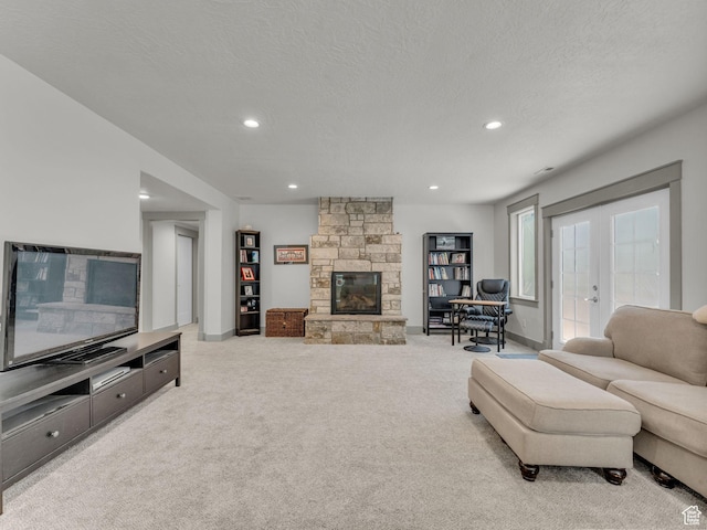 485 Parkview Dr, Summit Park, UT 84098 - living area featuring carpet floors, a stone fireplace, a textured ceiling, recessed lighting, and french doors