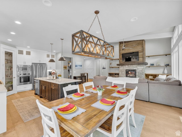 485 Parkview Dr, Summit Park, UT 84098 - dining space with a stone fireplace, light wood-style flooring, and recessed lighting