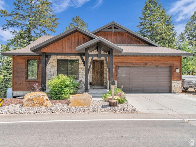 485 Parkview Dr, Summit Park, UT 84098 - view of front of house featuring stone siding, an attached garage, concrete driveway, and roof with shingles