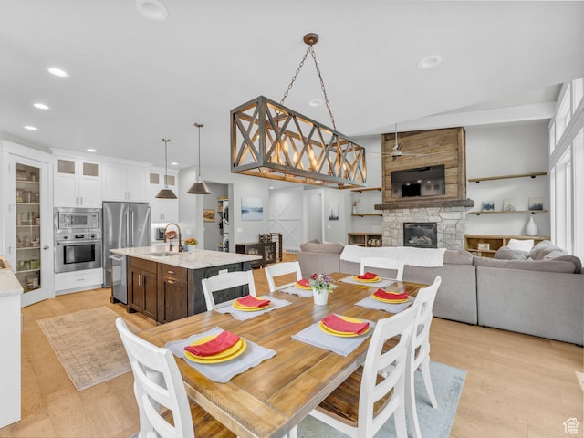 485 Parkview Dr, Summit Park, UT 84098 - dining space with a stone fireplace, recessed lighting, and light wood-style flooring