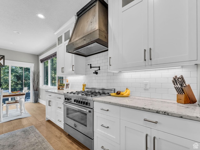 485 Parkview Dr, Summit Park, UT 84098 - kitchen featuring stainless steel range, custom range hood, white cabinetry, glass insert cabinets, and recessed lighting