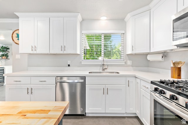 520 990 N, Pleasant Grove, UT 84062 - kitchen with appliances with stainless steel finishes, white cabinetry, beverage cooler, and crown molding