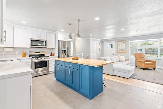 520 990 N, Pleasant Grove, UT 84062 - kitchen featuring appliances with stainless steel finishes, open floor plan, recessed lighting, blue cabinetry, and white cabinets