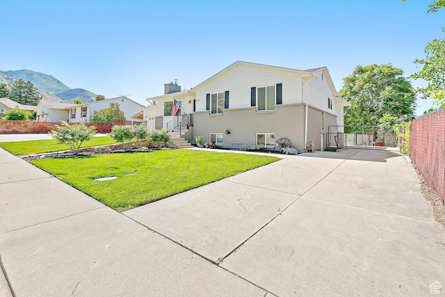 520 990 N, Pleasant Grove, UT 84062 - view of front of home with a gate, concrete driveway, and a chimney