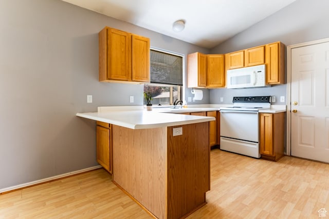 231 Amanda Lynn Ln, Midvale, UT 84047 - kitchen with white appliances, light wood-style flooring, a peninsula, vaulted ceiling, and light countertops
