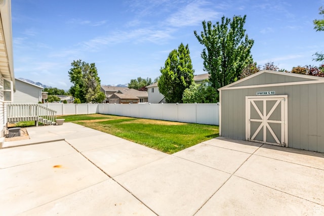 231 Amanda Lynn Ln, Midvale, UT 84047 - fenced backyard featuring a storage shed and a patio