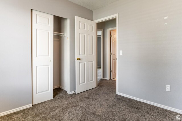 231 Amanda Lynn Ln, Midvale, UT 84047 - unfurnished bedroom featuring dark carpet and a closet