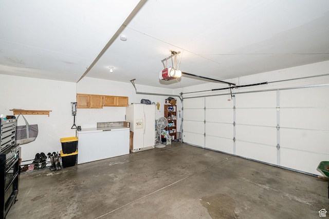 4922 S 2925 W, Roy, UT 84067 - garage featuring white refrigerator with ice dispenser and a garage door opener