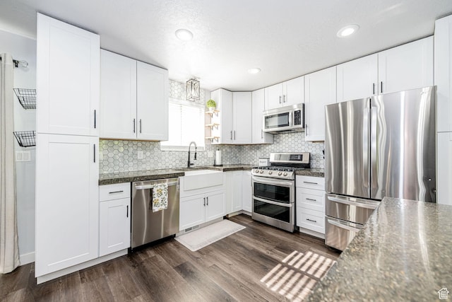 4922 S 2925 W, Roy, UT 84067 - kitchen with stainless steel appliances, dark countertops, backsplash, and recessed lighting
