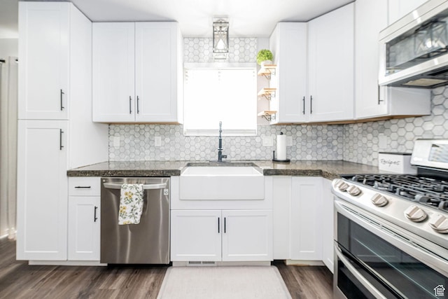 4922 S 2925 W, Roy, UT 84067 - kitchen with appliances with stainless steel finishes, white cabinets, backsplash, and dark wood finished floors