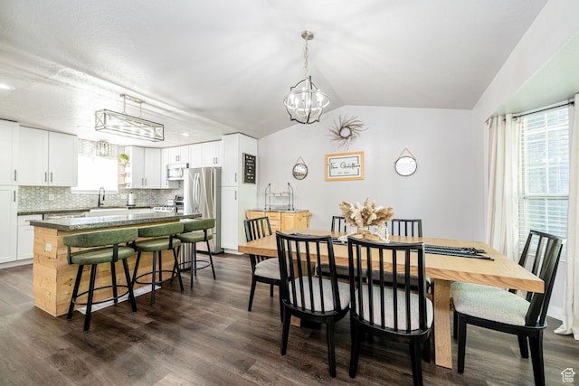 4922 S 2925 W, Roy, UT 84067 - dining area with a chandelier, dark wood-type flooring, and vaulted ceiling