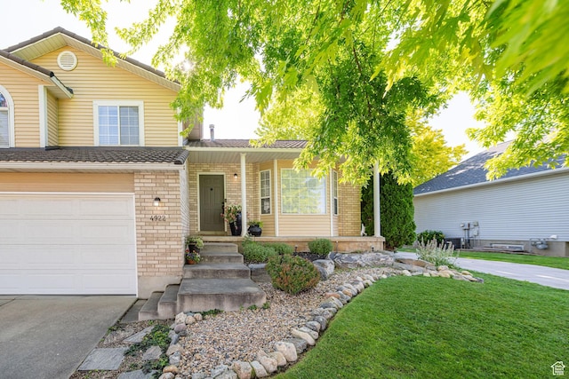 4922 S 2925 W, Roy, UT 84067 - traditional-style house featuring brick siding, an attached garage, concrete driveway, a front yard, and covered porch