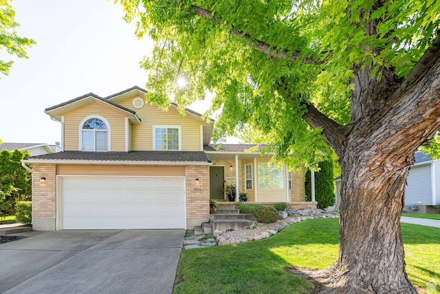4922 S 2925 W, Roy, UT 84067 - view of front of home with driveway, brick siding, an attached garage, and a front lawn