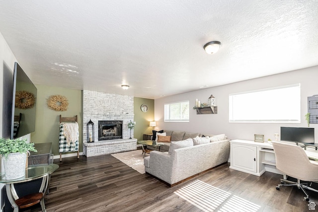 4922 S 2925 W, Roy, UT 84067 - living room with wood finished floors, a fireplace, a textured ceiling, and a desk