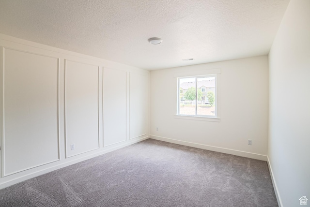 7169 W Moorepark Pl, West Jordan, UT 84081 - carpeted spare room featuring baseboards and a textured ceiling