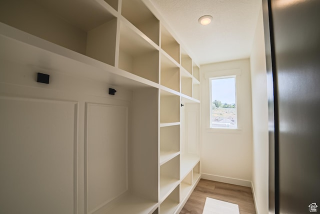 7169 W Moorepark Pl, West Jordan, UT 84081 - mudroom with baseboards and light wood-style flooring