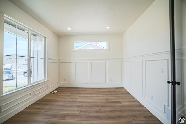 7169 W Moorepark Pl, West Jordan, UT 84081 - spare room with a decorative wall, wood finished floors, a wainscoted wall, and recessed lighting