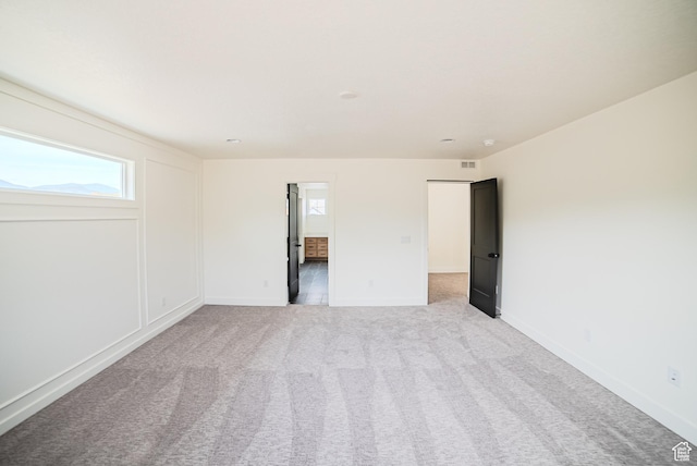 7169 W Moorepark Pl, West Jordan, UT 84081 - empty room with plenty of natural light and light colored carpet