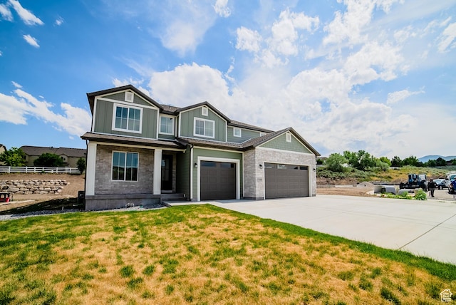 7169 W Moorepark Pl, West Jordan, UT 84081 - craftsman house featuring driveway, board and batten siding, stone siding, a porch, and an attached garage