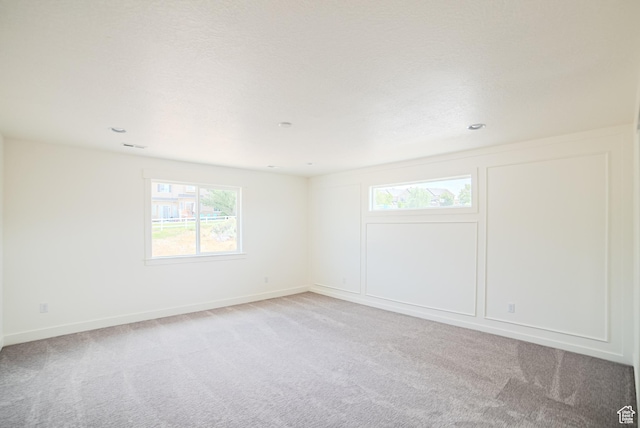 7169 W Moorepark Pl, West Jordan, UT 84081 - spare room featuring light colored carpet