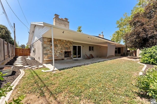 4281 S Nielsen Way, West Valley City, UT 84119 - back of property with a chimney, a fenced backyard, a patio, and stone siding
